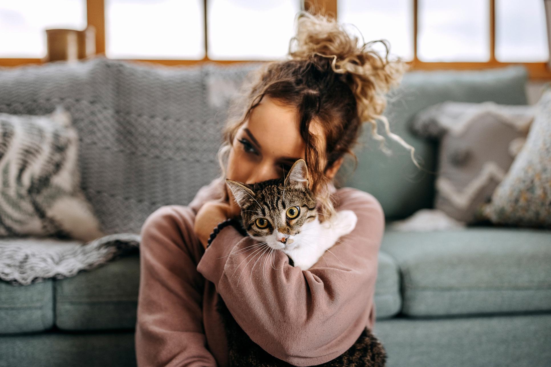 Young woman bonding with her cat.